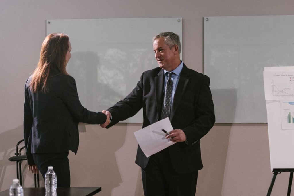 Business colleagues shaking hands, representing corporate agreements and company formation in Pakistan