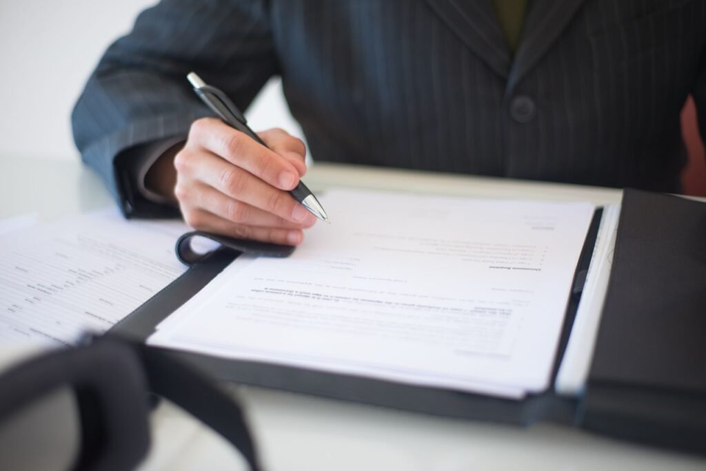 Small business contract documents being reviewed and signed in Pakistan