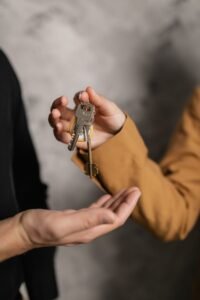 Handing over house keys, representing property transfer in Pakistan