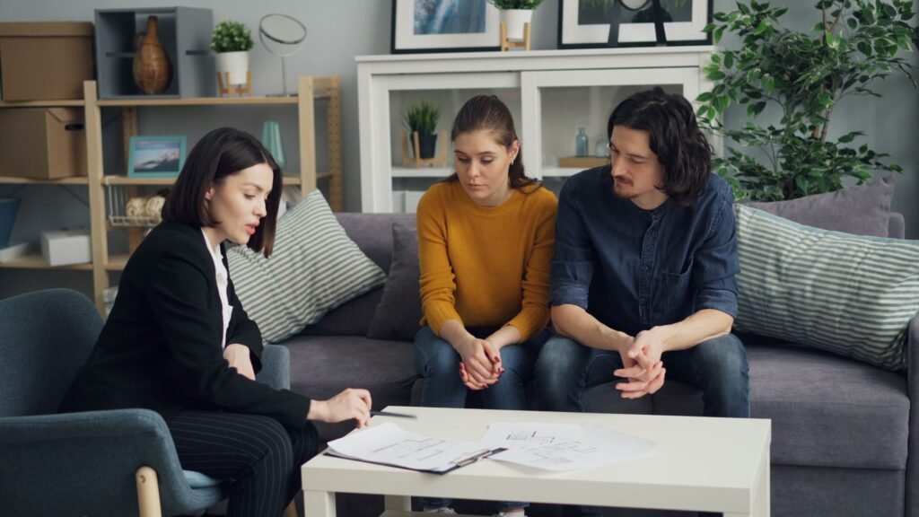 Couple consulting with a legal advisor about a property matter, representing property ownership disputes in Pakistan