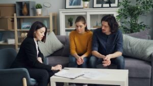 Couple consulting with a legal advisor about a property matter, representing property ownership disputes in Pakistan