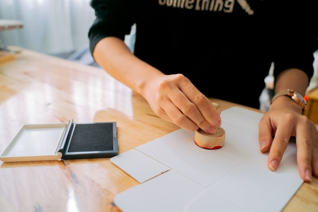 Hand stamping an official document, representing succession certificate issuance in Pakistan